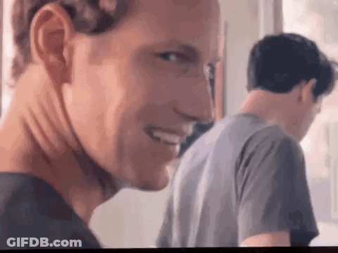 Man Smiling At Camera With Man Behind GIF
