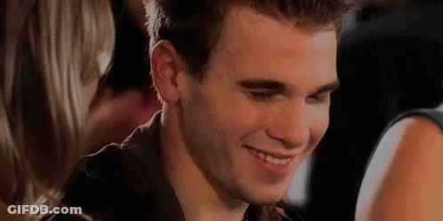 Man Smiling At Woman In Crowd GIF