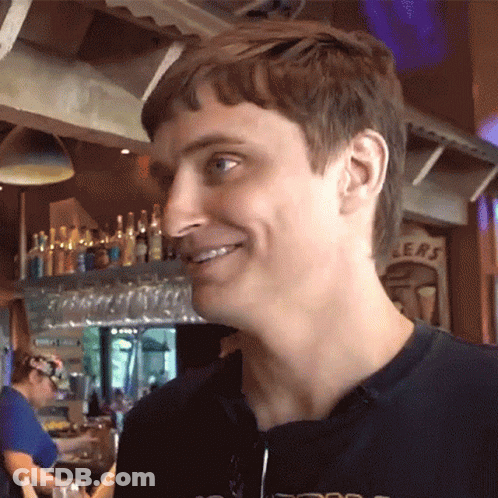 Man Smiling Beside Sign Saying Ers GIF