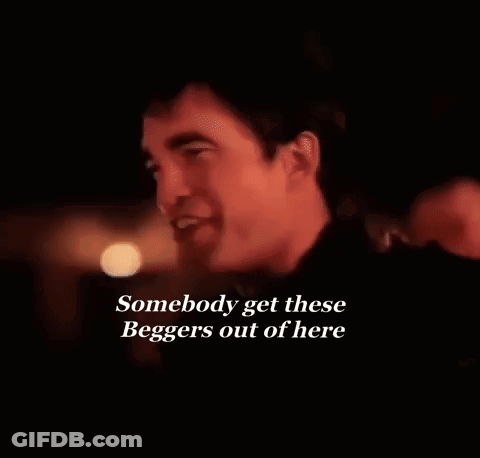 Man Smiling Dark Room Saying Somebody Get These Beggars Out Of Here GIF