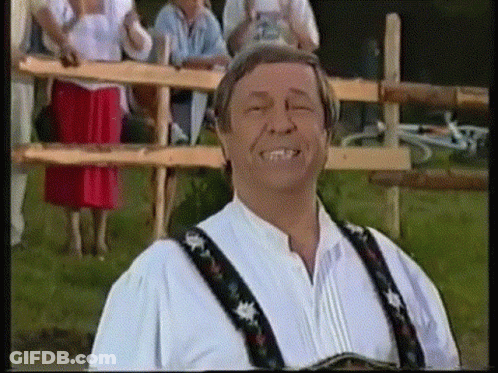Man Smiling Eyes Closed By Wooden Fence GIF