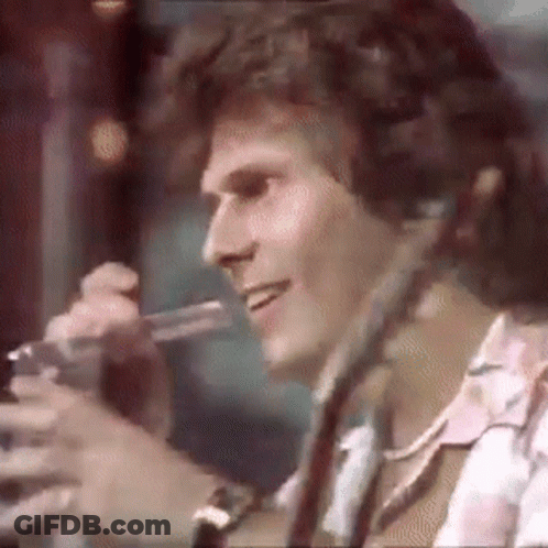 Man Smiling Holding Microphone With Headphones GIF