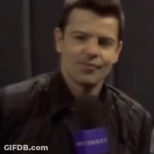 Man Smiling Holding Yahoo Microphone GIF