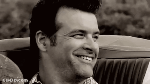 Man Smiling In Black And White Convertible Car GIF
