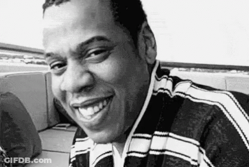 Man Smiling In Black And White On Couch GIF