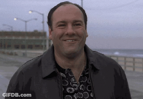 Man Smiling In Black Jacket And Polka Dot Shirt GIF