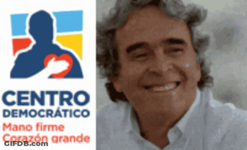 Man Smiling In Front Of Centro Democrático Logo GIF