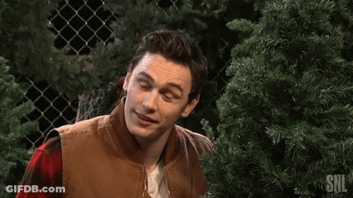 Man Smiling In Front Of Christmas Tree GIF
