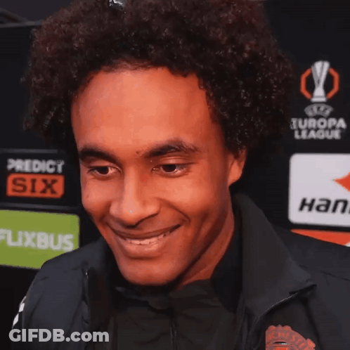 Man Smiling In Front Of Europa League Advertisement GIF