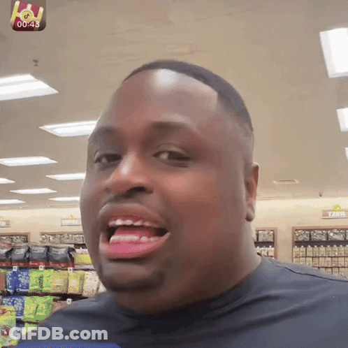 Man Smiling In Front Of Farm Sign GIF