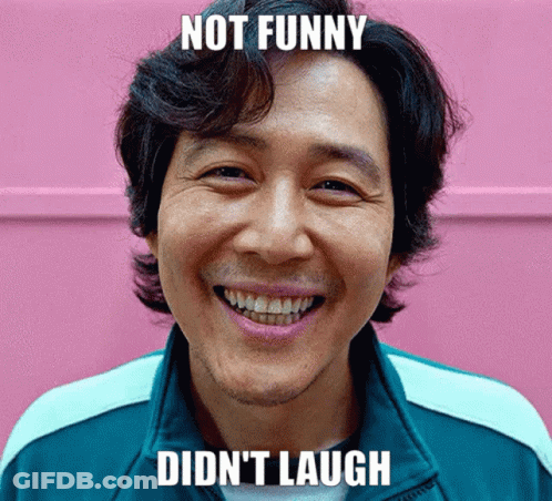 Man Smiling In Front Of Pink Wall Not Funny Didn't Laugh GIF