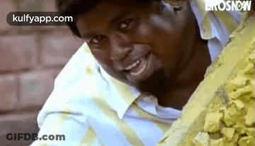 Man Smiling In Front Of Rocks GIF
