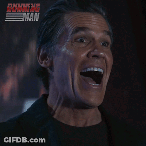 Man Smiling In Front Of Running Poster GIF