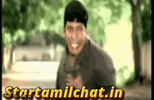 Man Smiling In Front Of Startamilchat.in Sign GIF