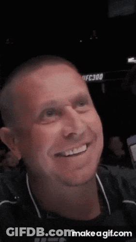 Man Smiling In Front Of UFC300 Sign GIF