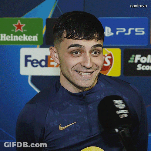 Man Smiling In Nike Shirt In Front Of FedEx Sign GIF