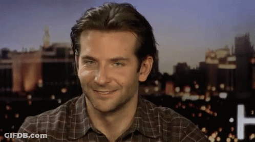Man Smiling In Plaid Shirt At Night City GIF