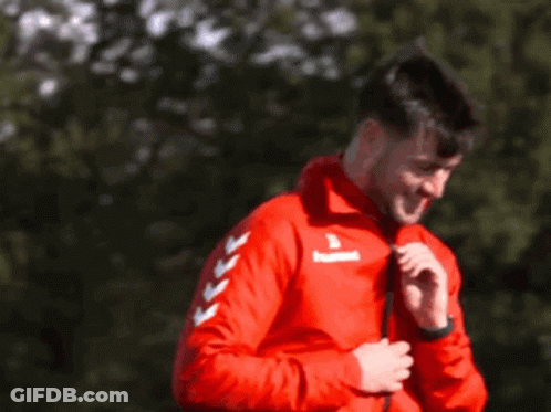 Man Smiling In Red Jacket With Arrows GIF