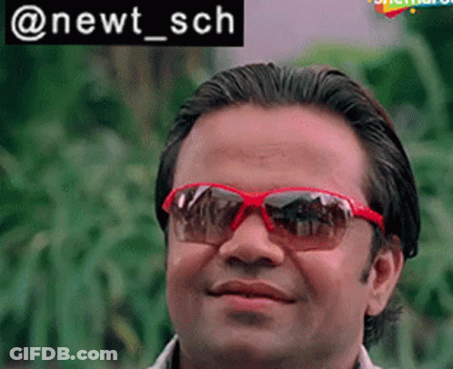 Man Smiling In Red Sunglasses With Plants GIF