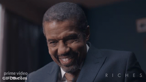 Man Smiling In Suit In Front Of Prime Video Riches GIF