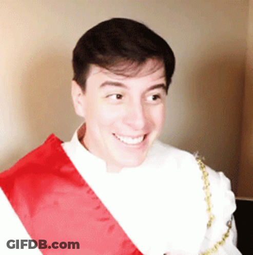 Man Smiling In White Shirt And Red Sash GIF