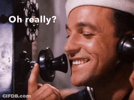 Man Smiling On Phone Saying Oh Really GIF