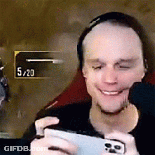 Man Smiling Playing Video Game On Cell Phone GIF