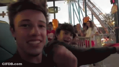 Man Smiling Riding Roller Coaster GIF