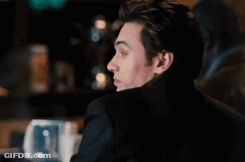 Man Smiling Sitting At Bar GIF