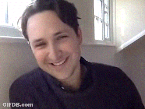 Man Smiling Sitting In Front Of Window GIF