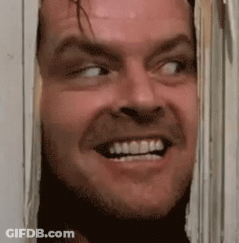 Man Smiling Through Hole In Wall GIF