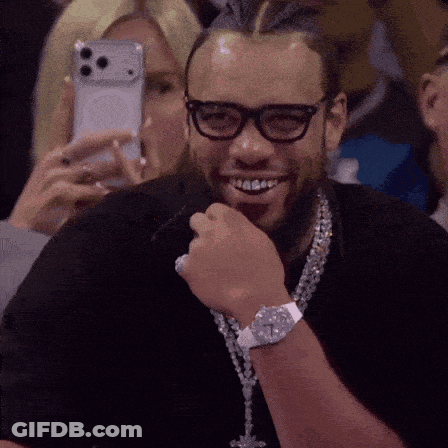 Man Smiling While Woman Takes Photo GIF