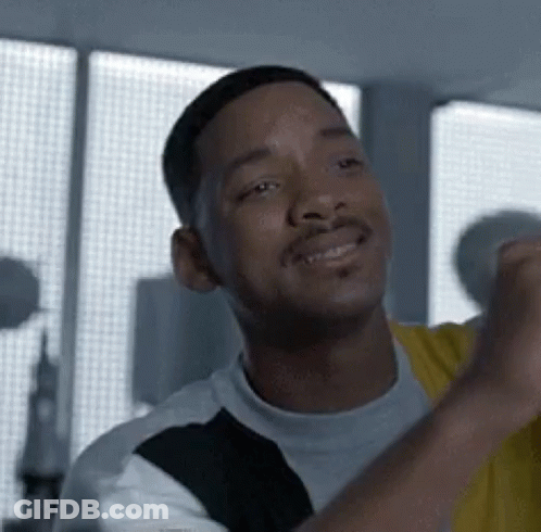 Man Smiling With Fist Up At Window GIF