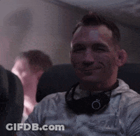 Man Smiling With Headphones On Airplane GIF