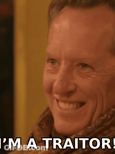 Man Smiling With I'm A Traitor Behind Him GIF