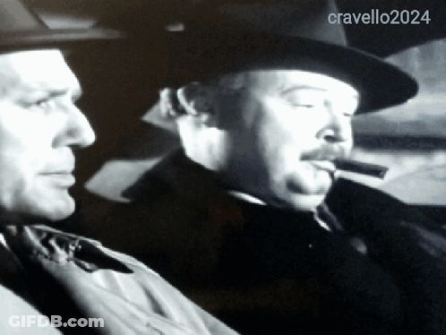 Man Smoking Cigar Next To Cravello 2024 GIF