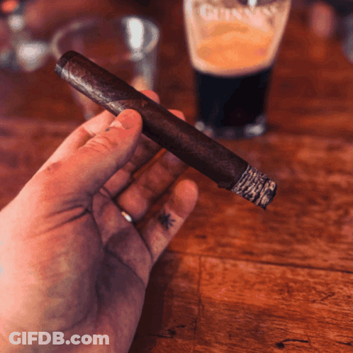 Man Smoking Cigar With Arm Tattoo GIF