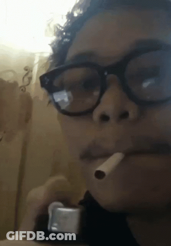 Man Smoking Cigarette Eyes Closed In Dark Room GIF