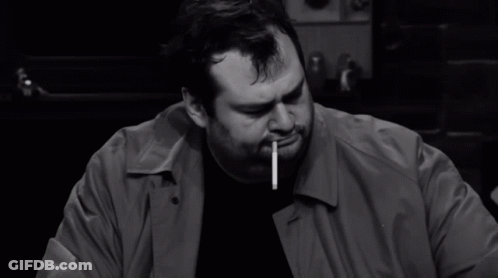 Man Smoking Cigarette Holding Paper GIF