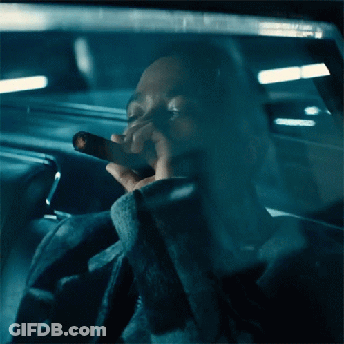 Man Smoking Cigarette In Car With Eyes Closed GIF