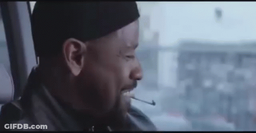 Man Smoking Cigarette In Car With Hat GIF