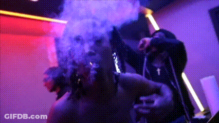 Man Smoking Cigarette In Dark Room With Smoke GIF