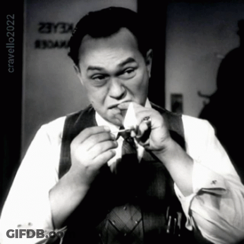 Man Smoking Cigarette In Front Of Cravello20202 Sign GIF