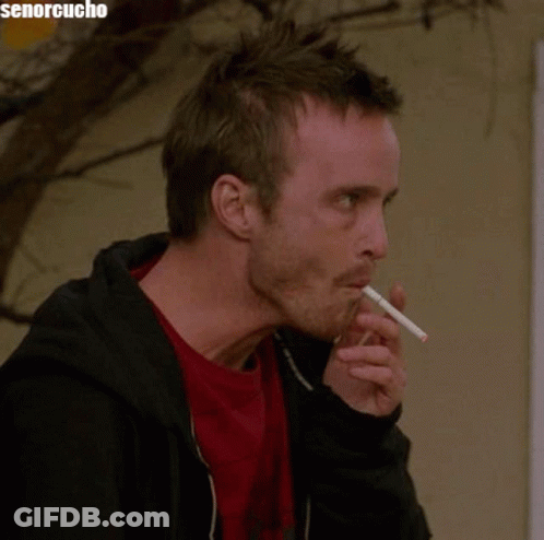 Man Smoking Cigarette In Front Of Senorcucho Sign GIF