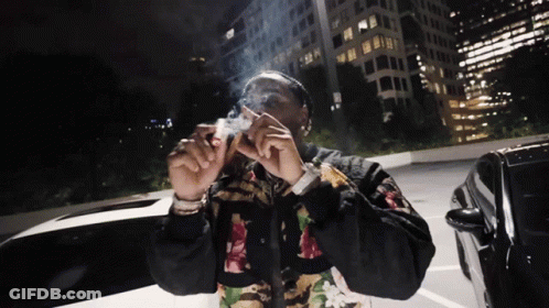 Man Smoking Cigarette In Parking Lot At Night GIF