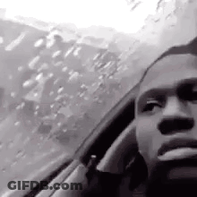 Man Smoking Cigarette Looking Out Car Window GIF