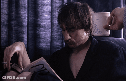 Man Smoking Cigarette Reading Book With Letter O GIF