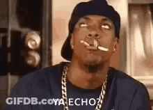Man Smoking Cigarette Wearing Hat And Chain GIF