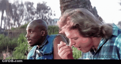 Man Smoking Cigarette While Another Man Looks On GIF