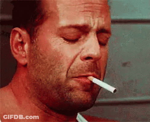 Man Smoking Cigarette With Eyes Closed GIF